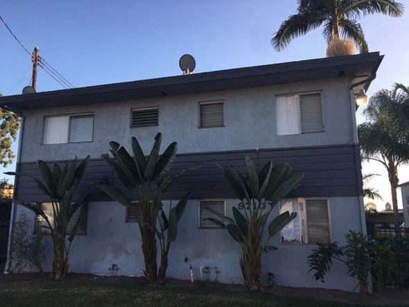 Bellflower apartment for rent - a white and black house with palm trees