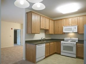 Middletown apartment for rent - a kitchen with white appliances and wooden cabinets