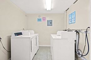 Downey apartment for rent - a laundry room with four washes and three dryers in it