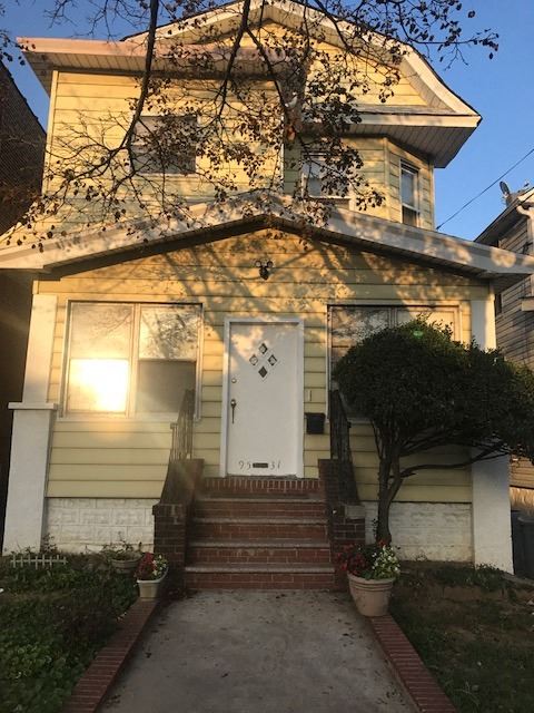 S. Richmond Hill apartment for rent - a small yellow house with a white door and stairs