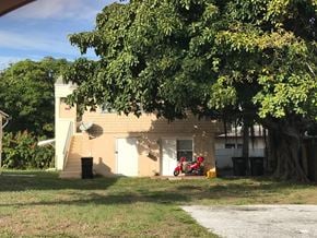West Palm Beach apartment for rent - a small house with a red motorcycle parked outside