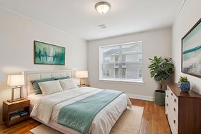 Allentown apartment for rent - A bedroom with a large bed and a painting on the wall.