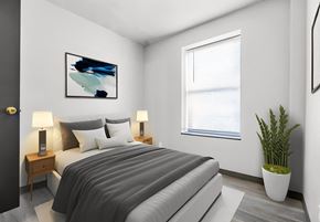 St Louis apartment for rent - a bedroom with a bed and a potted plant
