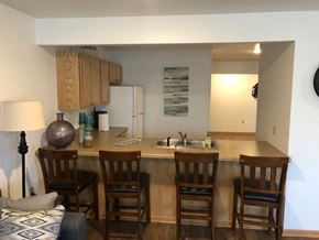 North Hudson apartment for rent - a kitchen with a bar with four chairs