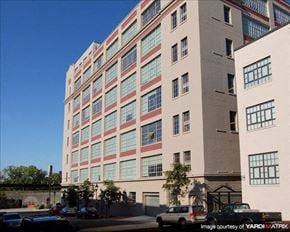 Richmond apartment for rent - a large building with cars parked in front of it