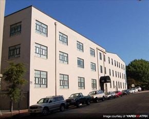 Richmond apartment for rent - a large white building with cars parked in front of it