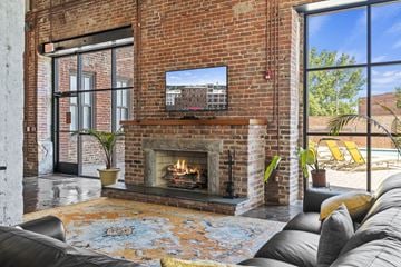 Richmond apartment for rent - the living room has a brick fireplace and a tv above it