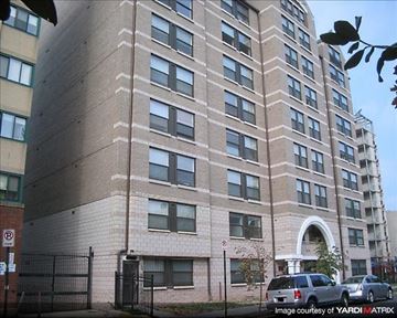 Washington apartment for rent - A tall building with a black gate in front.