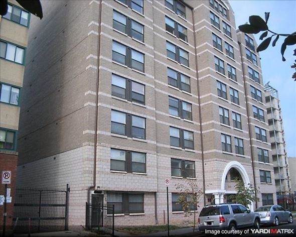 Washington apartment for rent - A tall building with a black gate in front.