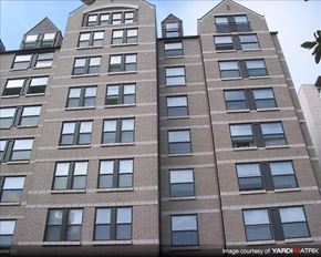 Washington apartment for rent - A tall brick building with many windows.