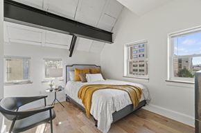 Washington apartment for rent - a bedroom with a bed and two windows