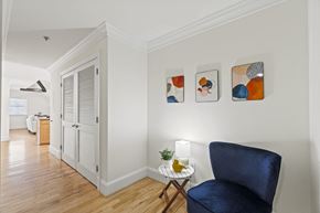 Washington apartment for rent - a living room with a blue chair and a door to a kitchen
