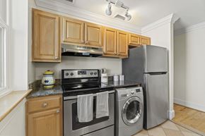 Washington apartment for rent - a kitchen with stainless steel appliances and wooden cabinets