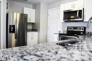 Gourmet kitchen with granite countertops & breakfast bar