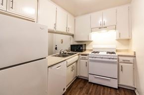 North Hollywood apartment for rent - A white kitchen with a refrigerator, oven, and microwave.