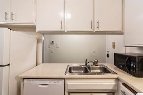 North Hollywood apartment for rent - A kitchen with a white fridge, microwave, and dishwasher.