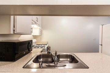 North Hollywood apartment for rent - A kitchen with a sink and a microwave.