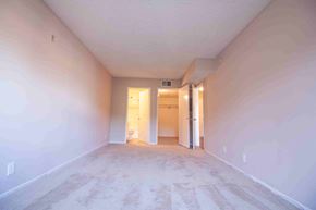 North Hollywood apartment for rent - A long, empty hallway with a carpeted floor and white walls.