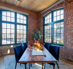 Lowell apartment for rent - a dining room with large windows and a wooden table