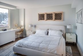 New York apartment for rent - a bedroom with a bed and a desk and a window