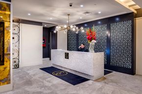 New York apartment for rent - a man sitting at a desk in a lobby of a building