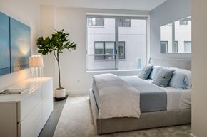 New York apartment for rent - a bedroom with a bed and a large window