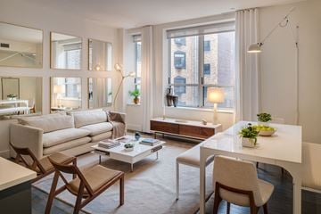 New York apartment for rent - a living room with a white couch and a table