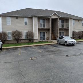 Aurora apartment for rent - a apartment building with a car parked in a parking lot