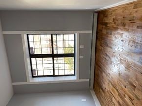Brooklyn apartment for rent - an empty room with a window and a wooden wall