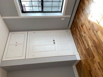 Brooklyn apartment for rent - a white kitchen with white cabinets and a window