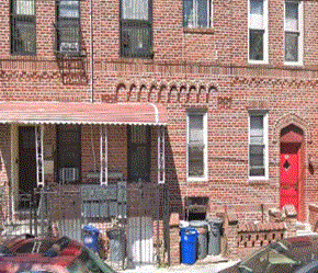 Brooklyn apartment for rent - A red brick building with a red door and a red car parked in front.