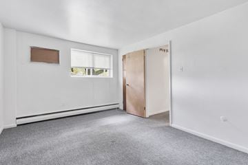 Philadelphia apartment for rent - an empty room with white walls and a window and a door