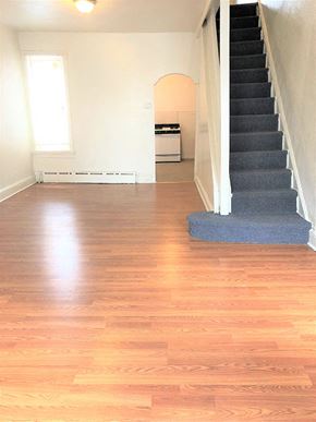 Philadelphia apartment for rent - a living room with a staircase and wood floors