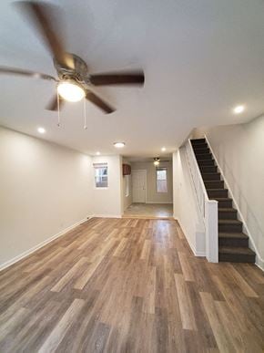 Philadelphia apartment for rent - an empty living room with a ceiling fan and stairs