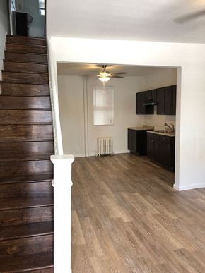 Philadelphia apartment for rent - an empty living room with wood floors and a staircase