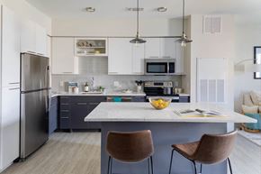 Woburn apartment for rent - a kitchen with a center island and a stainless steel refrigerator