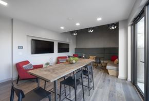 Woburn apartment for rent - a dining room with a wooden table and chairs and a television