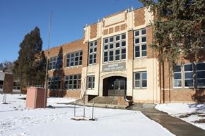 Mandan apartment for rent - a large brick building with snow in front of it