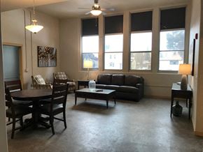 Mandan apartment for rent - an empty living room with a table and chairs