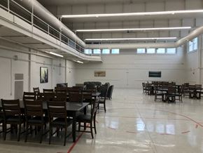 Mandan apartment for rent - a large room filled with tables and chairs in a hall