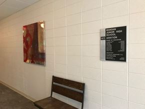 Mandan apartment for rent - a bench and a painting on the wall of a building