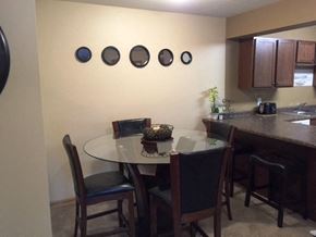 St Augusta apartment for rent - a dining area with a glass table and chairs