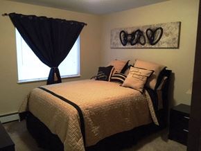 St Augusta apartment for rent - a bedroom with a bed and some pillows and a painting on the wall