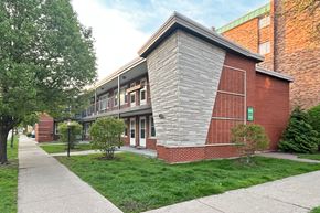 Forest Park apartment for rent - A building with a red brick exterior and a stone pillar.