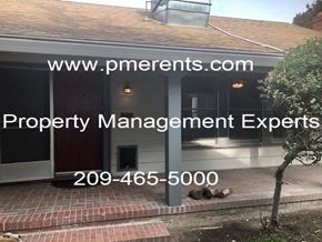 Stockton apartment for rent - A house with a sign that says Property Management Experts.