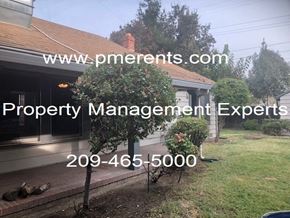 Stockton apartment for rent - A house with a sign that says Property Management Experts.