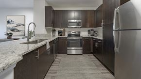 Tampa apartment for rent - a kitchen with stainless steel appliances and marble counter tops