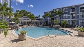 Tampa apartment for rent - a swimming pool in front of an apartment building