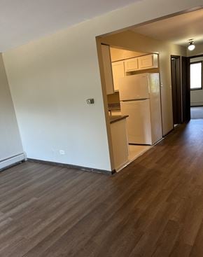 Oak Forest apartment for rent - A kitchen with a white fridge and wooden floors.