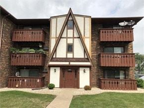 Oak Forest apartment for rent - A brown and white building with a triangular design in the front.